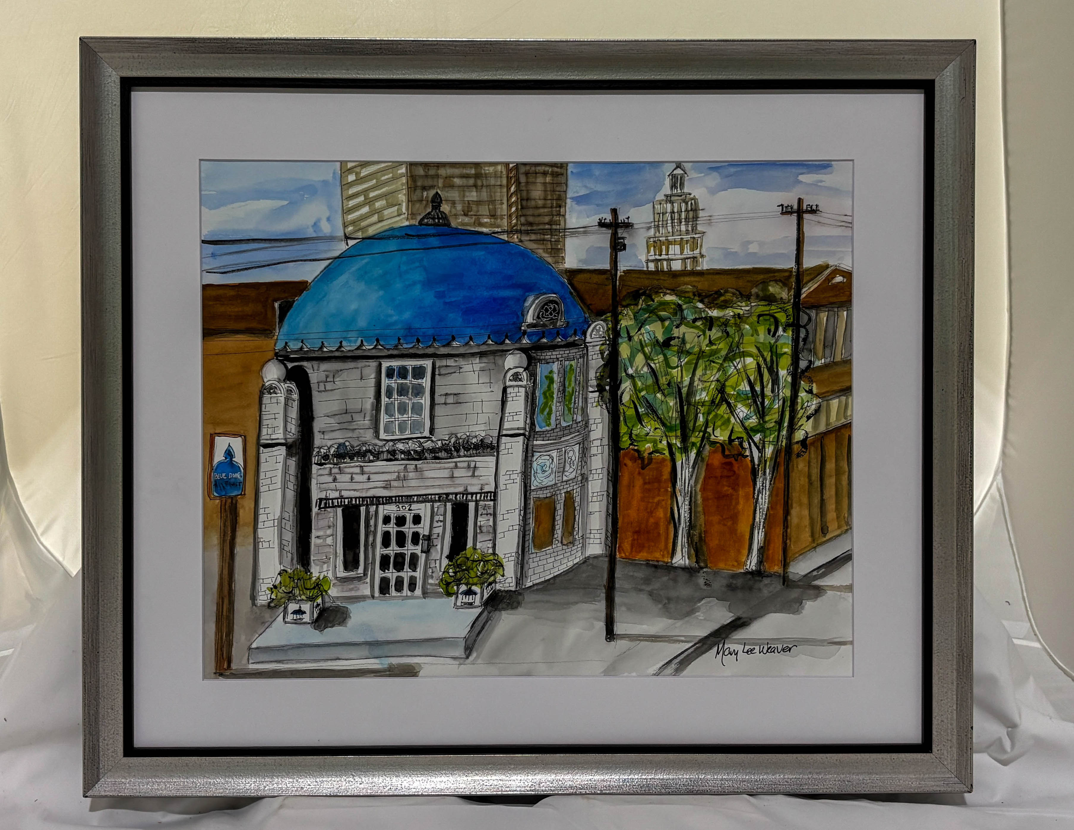 Framed artwork of a building with a blue dome