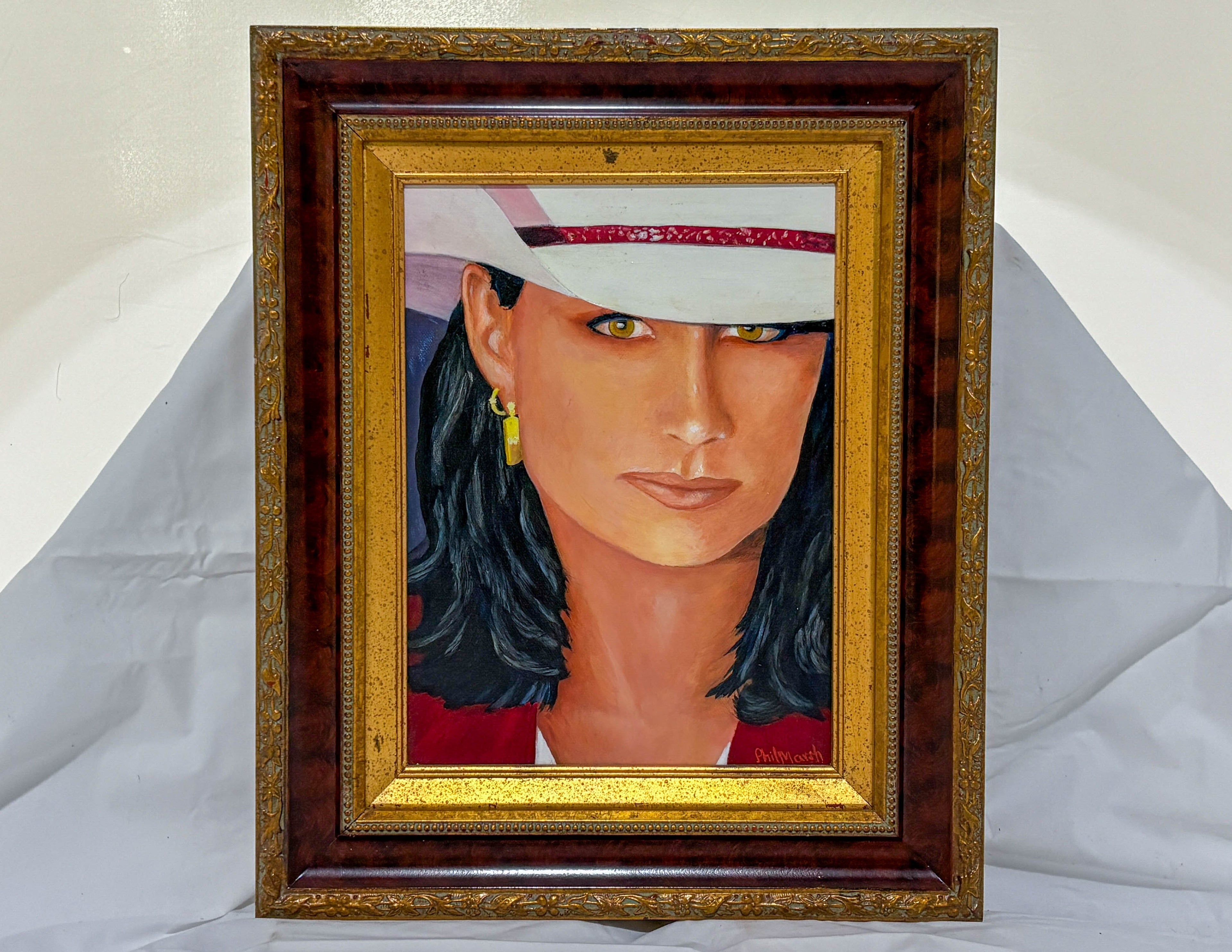 Framed portrait of a person with a white hat and red garment on a gray background