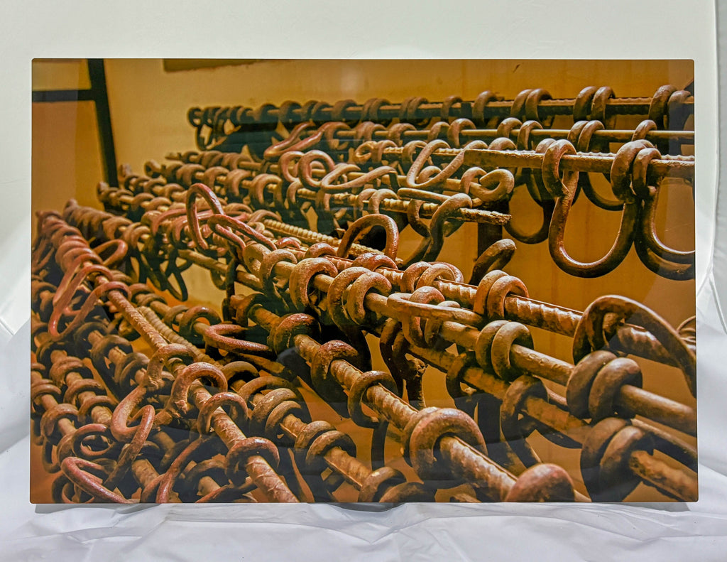 Rust-covered metal hooks on a yellow background